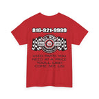 A red short-sleeve mechanic t-shirt with a large graphic print on the front. The graphic features the text '816-921-9999' in white, a central circular logo with '50' and 'All Star Auto Parts & Lube', checkered flags, and the text 'USED PARTS YOU NEED AT A PRICE YOU'LL LIKE! COME SEE US!' below.